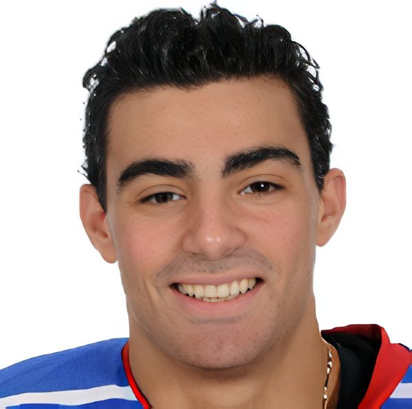 Smiling young hockey player in blue jersey