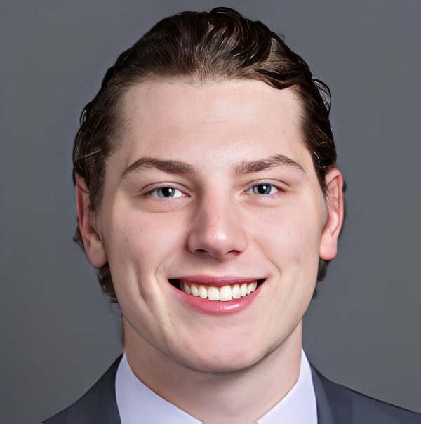 Smiling young man wearing suit headshot