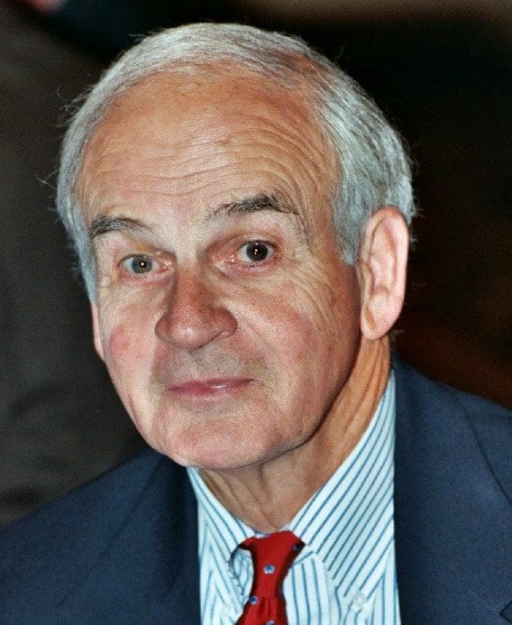Elderly man in suit and red tie