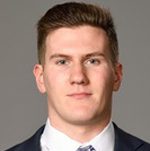 Professional headshot of man in suit