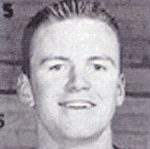 Black-and-white headshot of smiling young man