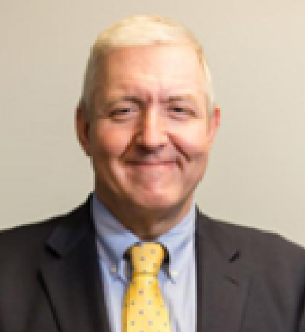 Smiling man in suit with yellow tie