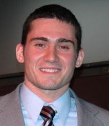 Smiling person wearing suit and tie