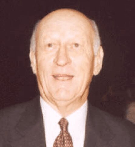 Elderly bald man in suit and tie smiling