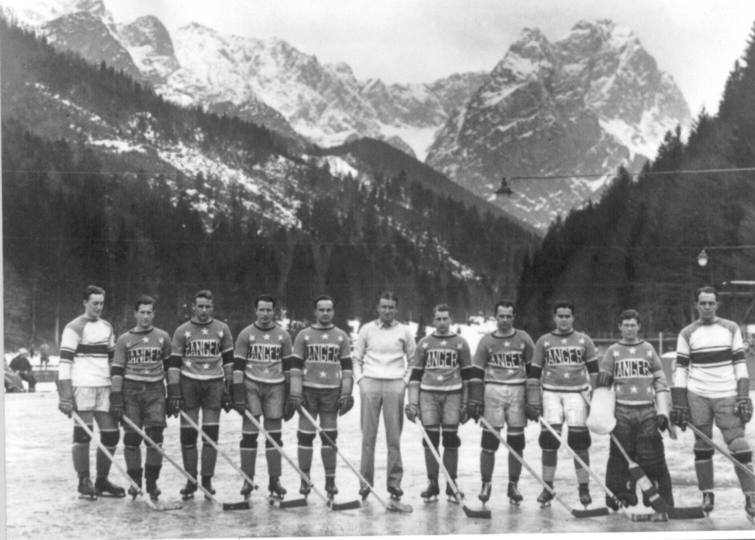 Vintage hockey team posing on mountain rink