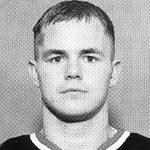 Black-and-white headshot of man in jersey