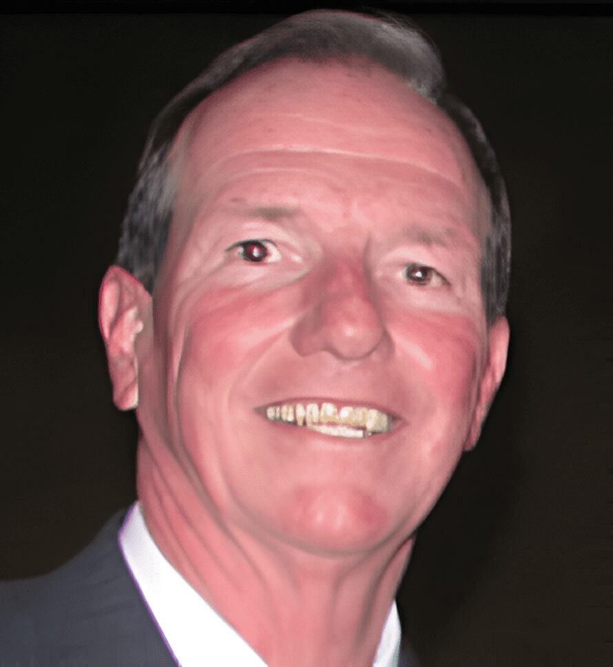 Close-up portrait of smiling man in suit