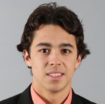 Young man in suit smiling at camera