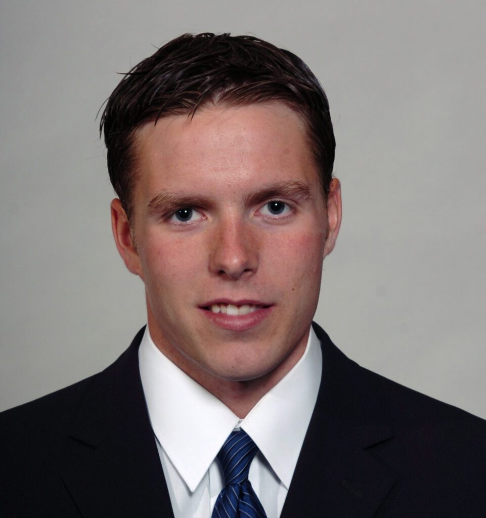 Headshot of man in suit and tie