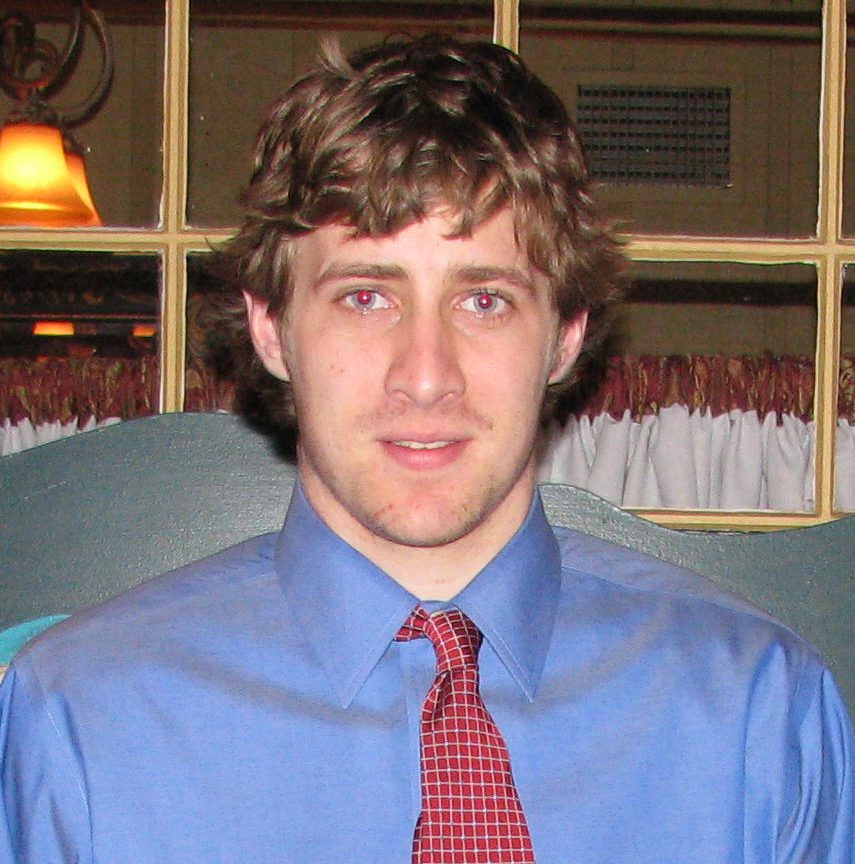 Man in blue shirt and red tie