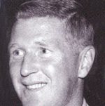 Black-and-white portrait of a smiling young man