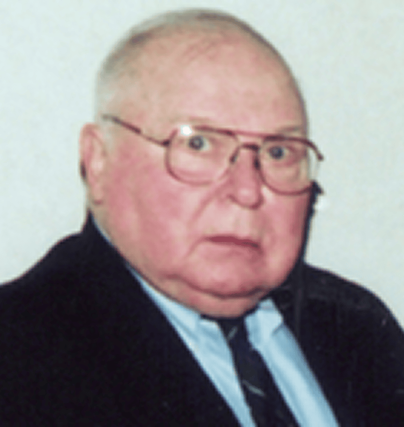 Elderly man wearing glasses and suit