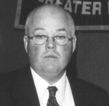 Black-and-white portrait of bald man with glasses