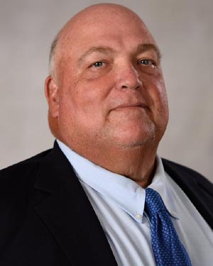 Portrait of bald man in suit and tie