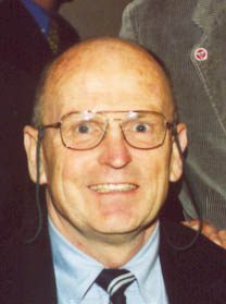 Smiling bald man wearing glasses and tie