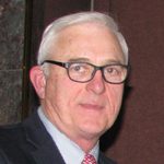 Older man portrait wearing suit and glasses