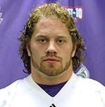 Man with curly hair wearing white sports jersey