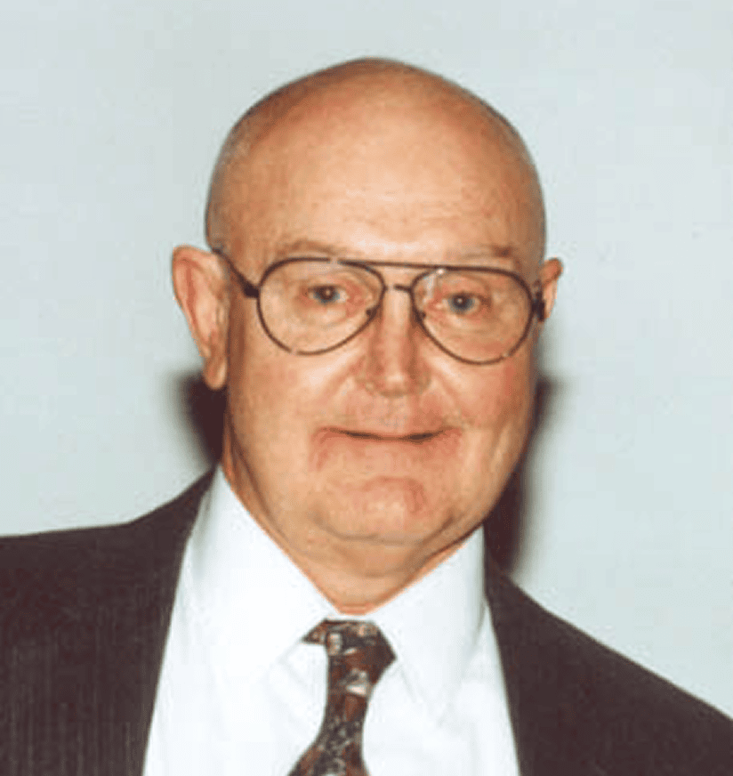Bald man in glasses, suit and tie