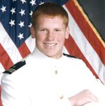Person in white uniform before American flag