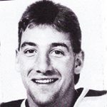 Black-and-white headshot of smiling young man