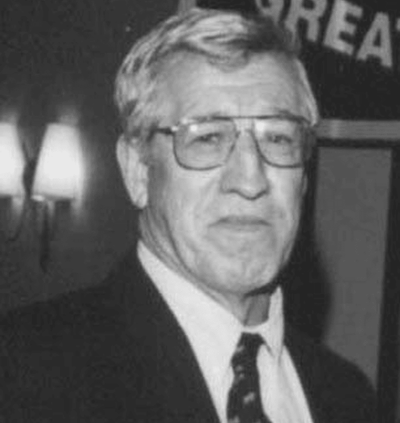 Older man wearing glasses and suit