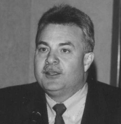Man in suit speaking into a microphone