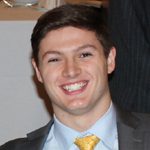 Smiling person in suit and yellow tie