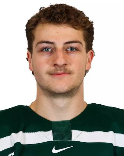 Young man wearing green hockey jersey