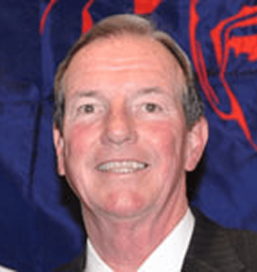 Smiling man in suit against blue background