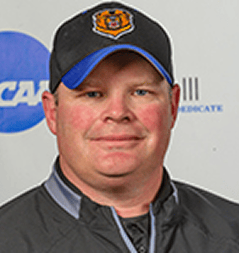 Man wearing black baseball cap and jacket