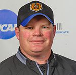Smiling man in baseball cap and jacket
