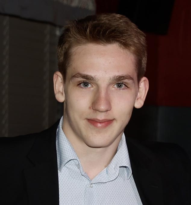 Young man in suit jacket smiling