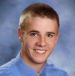 Smiling young man in blue shirt portrait