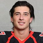 Smiling person in black and red hockey jersey