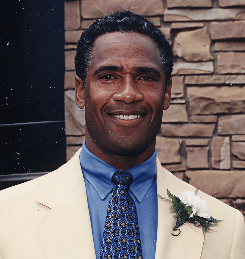 Smiling man in beige suit with boutonniere