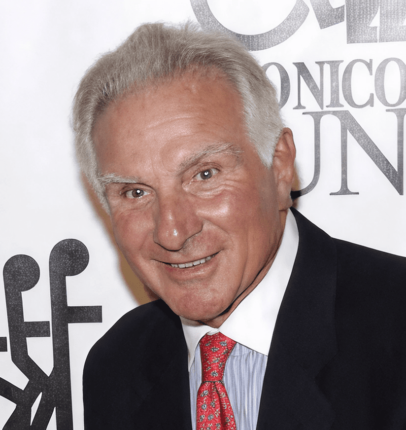 Smiling man in suit and red tie