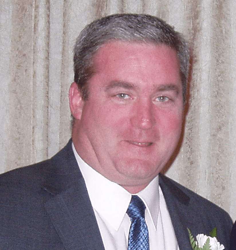 Smiling man in suit and blue tie