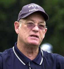 Older man wearing cap and glasses outdoors