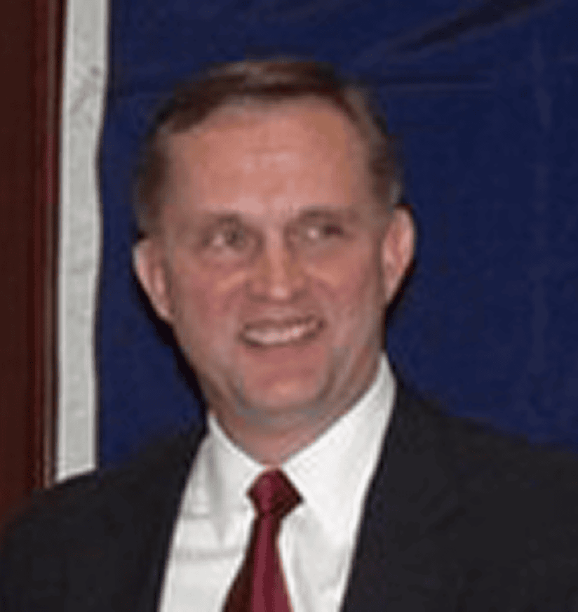 Smiling man in suit with red tie