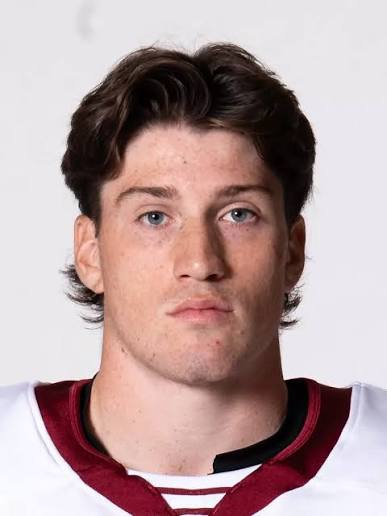 Young man wearing maroon and white hockey jersey