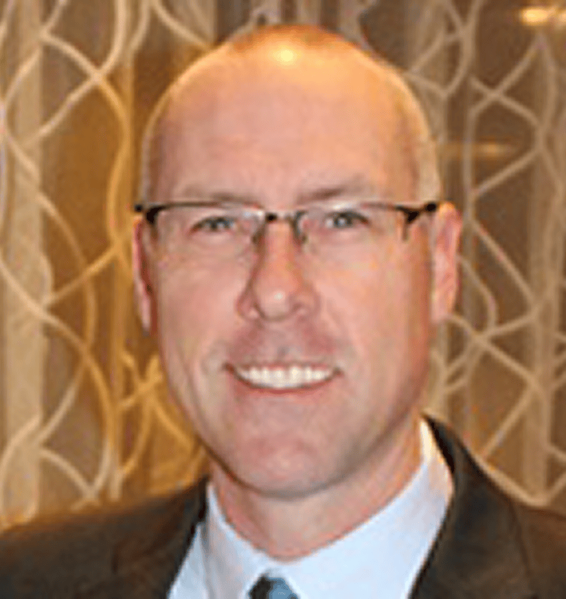 Smiling middle-aged man in suit and glasses