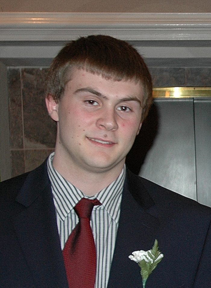 Young man in suit with red tie