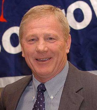 Smiling headshot of middle-aged man in suit