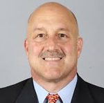 Smiling bald man in suit and tie