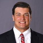 Headshot of smiling man in suit