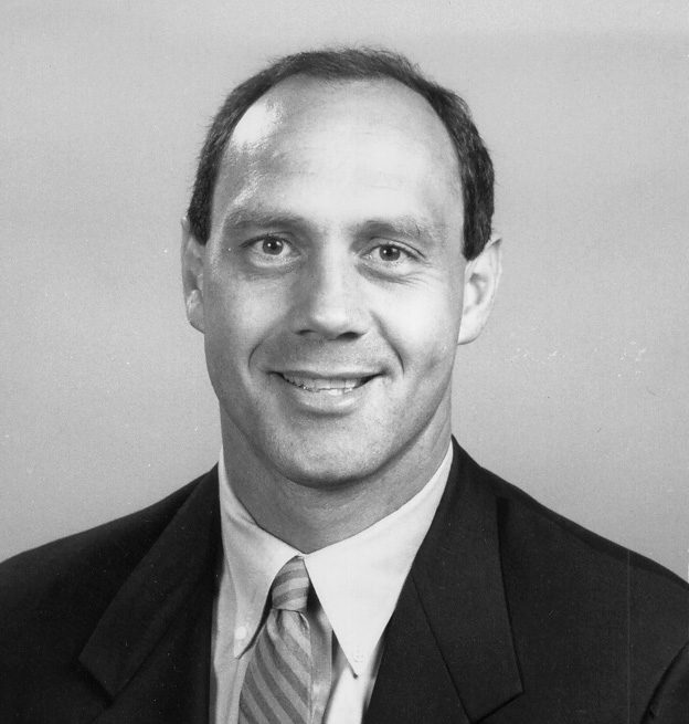 Smiling middle-aged man in suit and tie