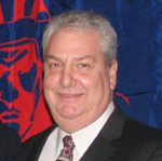 Smiling man in dark suit and tie
