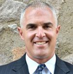 Smiling middle-aged man in suit outdoors