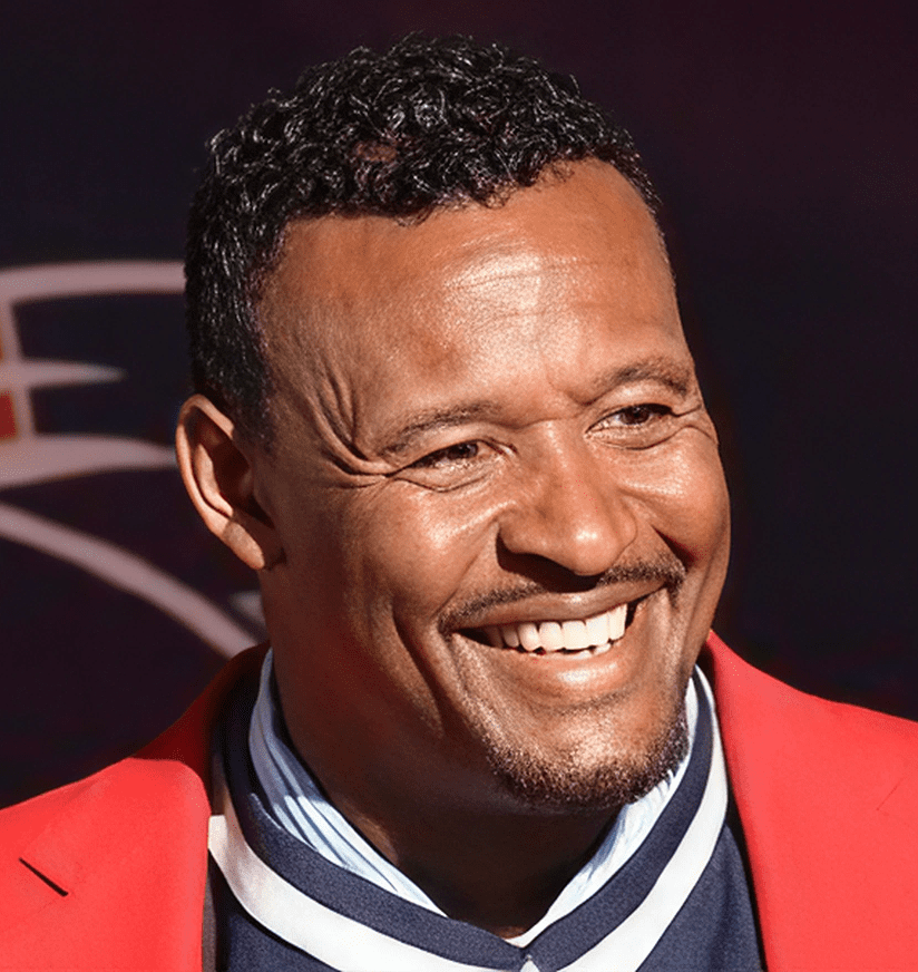 Smiling man in red jacket and striped scarf